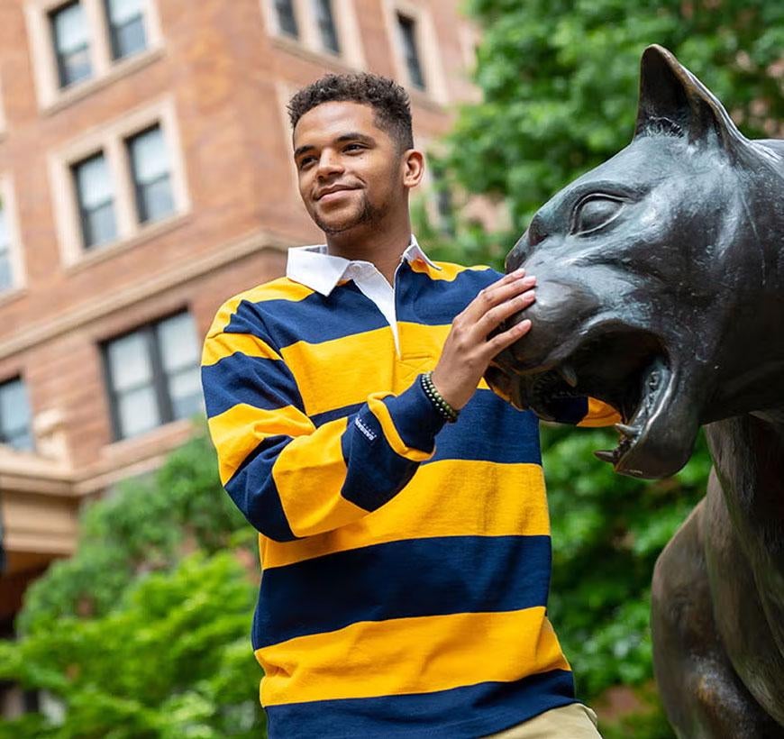 Student standing with Panther Statue